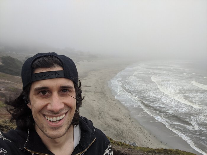 Pablo on some bluffs or cliffs or something, looking happy.