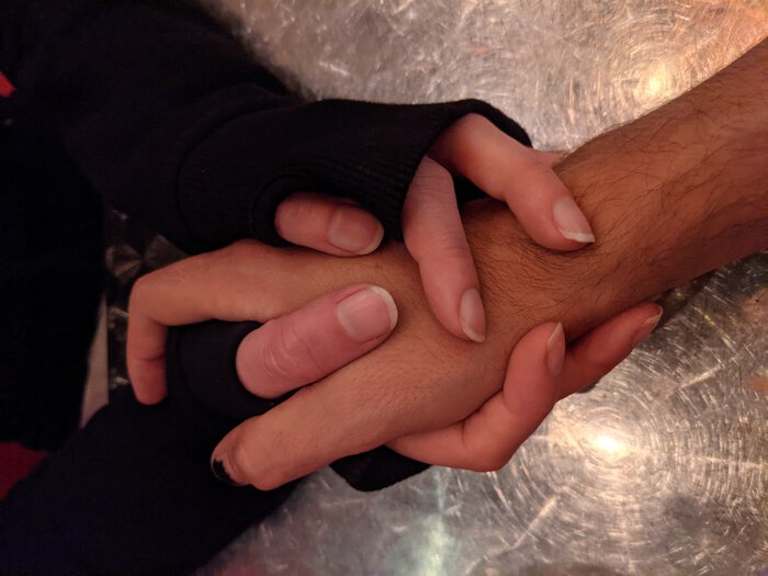 Photo of Karen and Pablo's hands, interlocked. Click for full size.