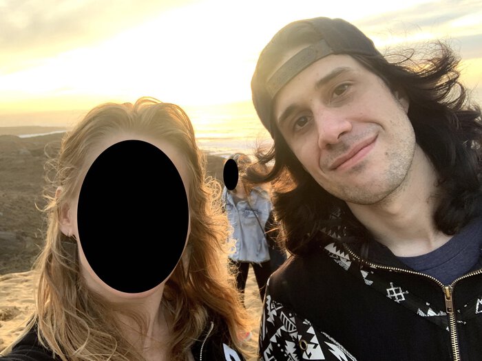 Karen and Pablo, her face redacted, at a beach. He looks happy. Click for full size.