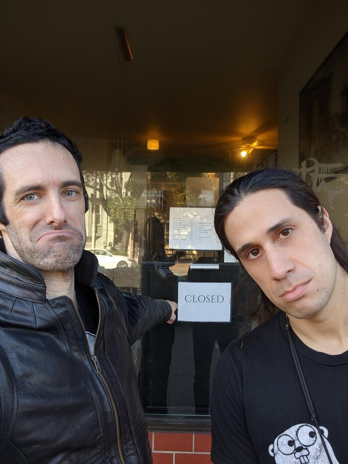 Pablo and friend pointing at a big closed sign. Click for full size.